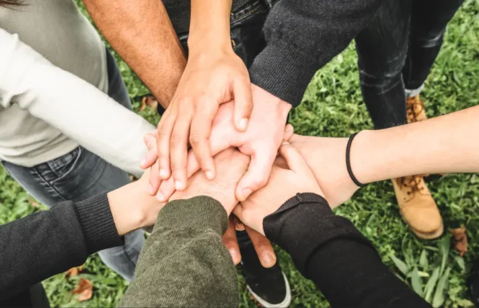 A group of people all putting their hands together