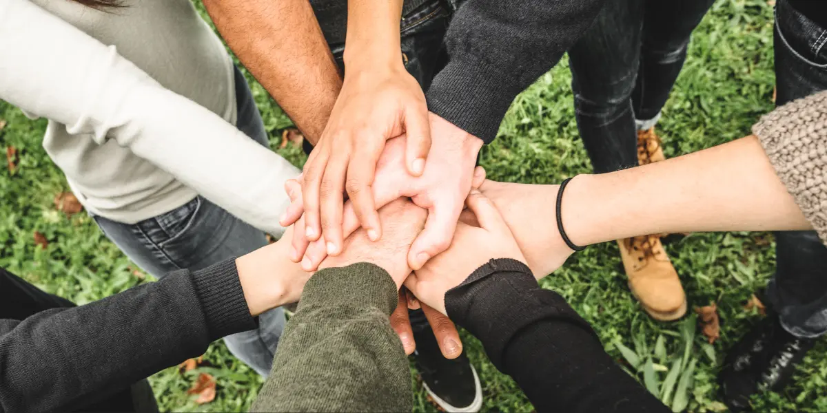 A group of people all putting their hands together