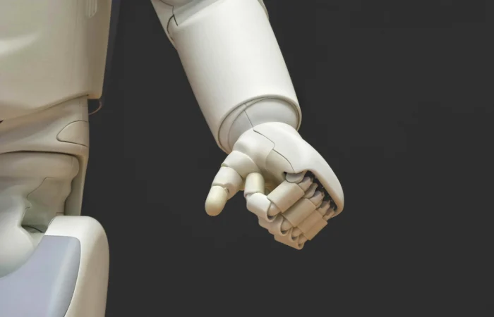 a white robot arm with the hand in a fist position