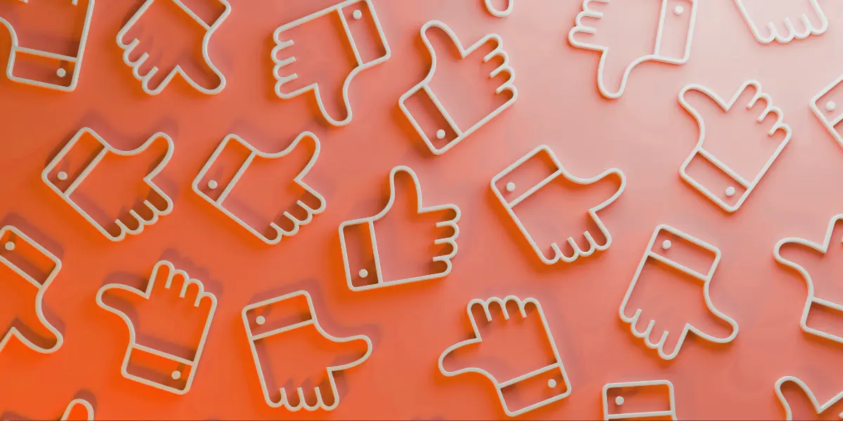 photo shows a bunch of thumbs up emojis in a pattern on an orange background